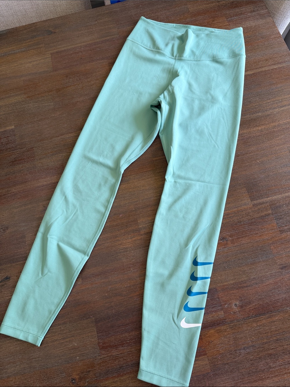 Nike Kids Mint Green Leggings with Blue and White Swoosh Accents